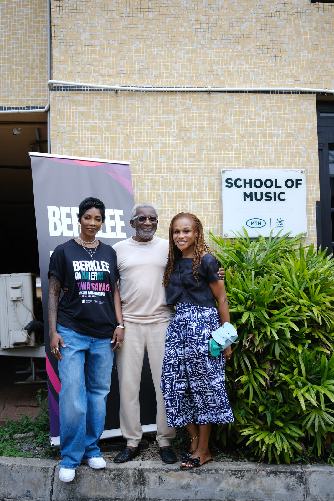 A participant at the Berklee in Nigeria backdrop
